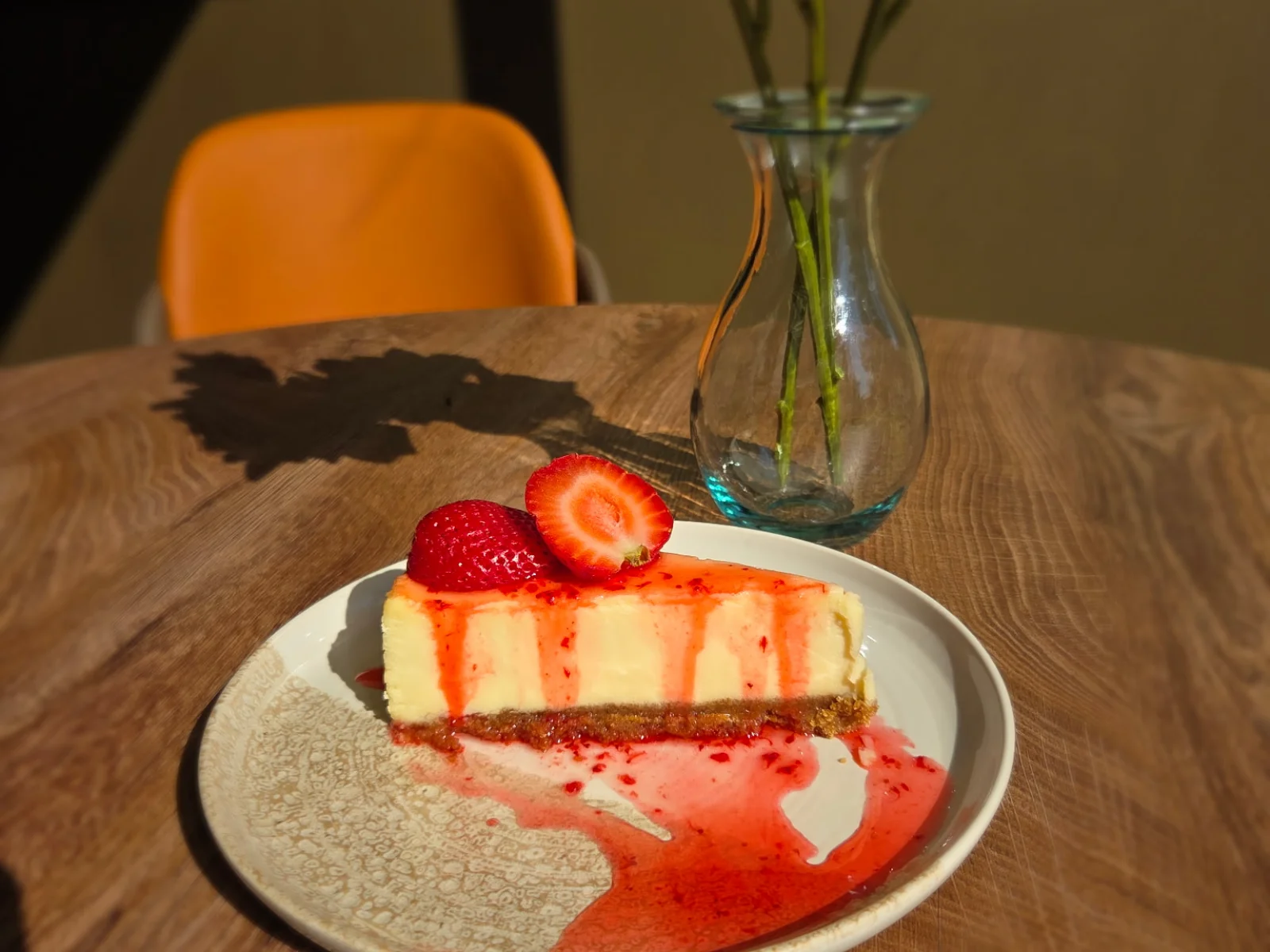 Strawberry cheesecake slice with strawberry coulis